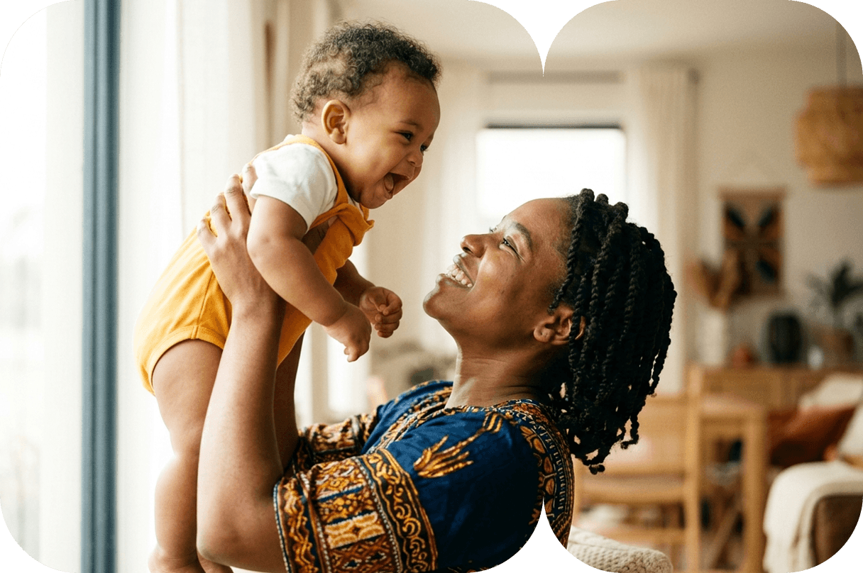 Mother lifting her happy baby